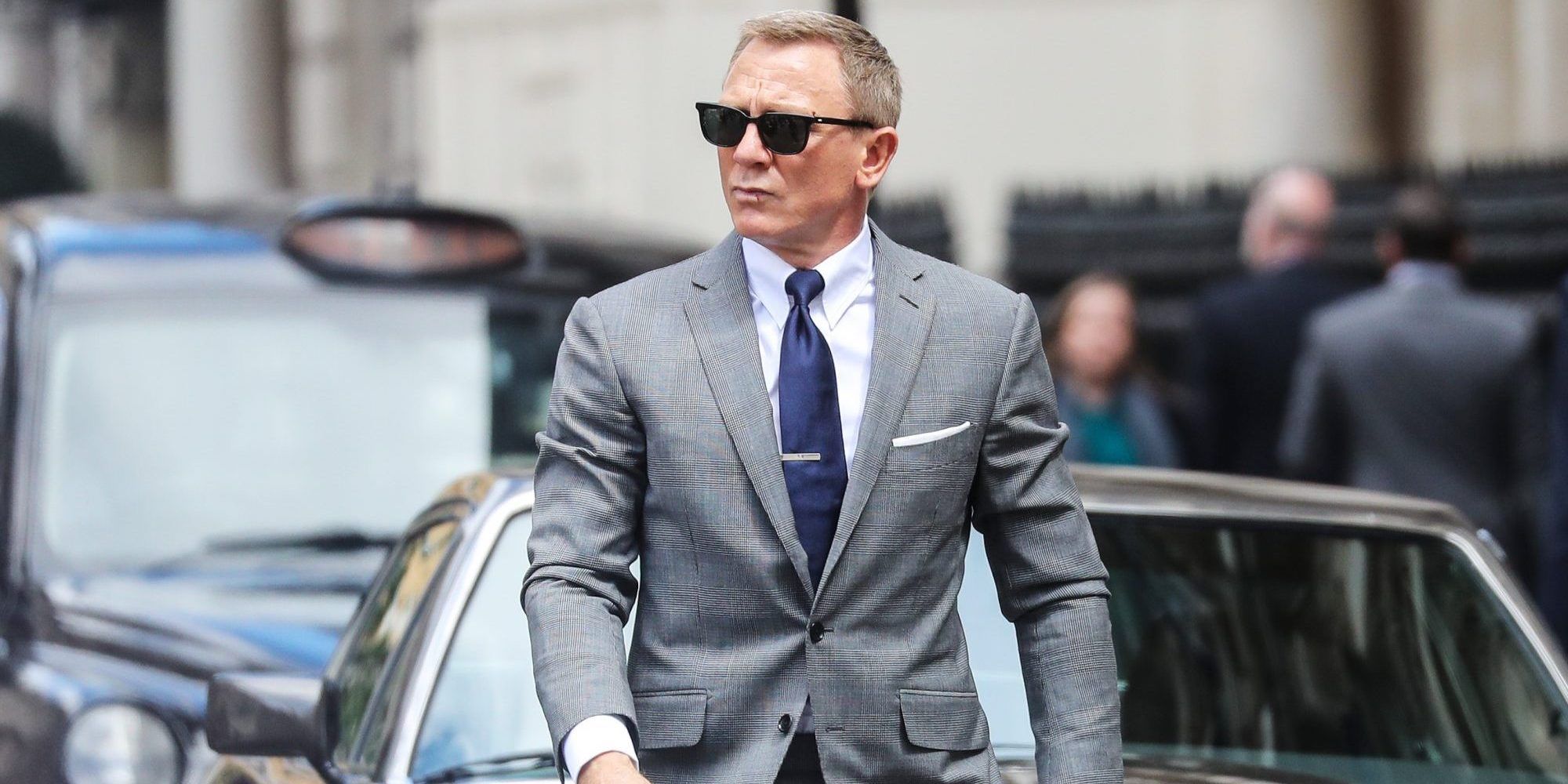Daniel Craig wearing a grey suit as James Bond
