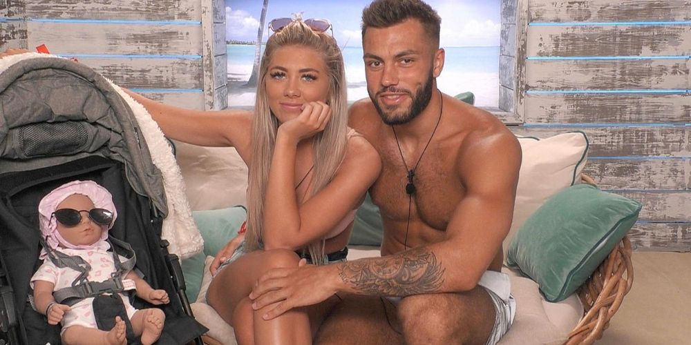 Paige and Finn sit with their baby on Love Island