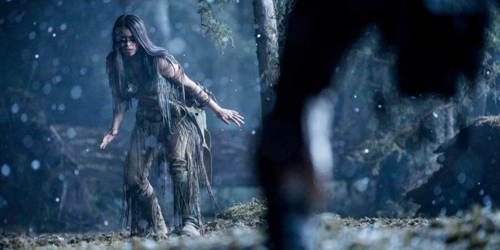 Amber Midthunder as Naru squaring off with the Predator in the rain in Prey