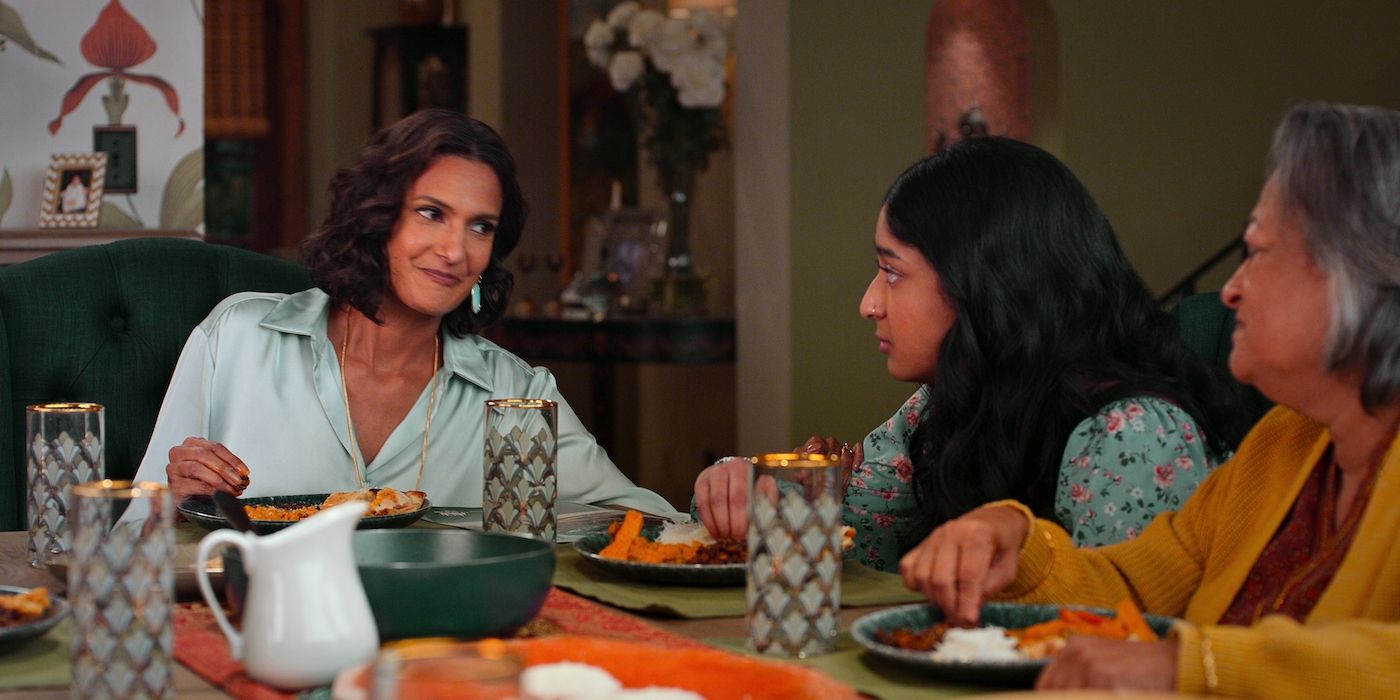 Devi sits with her mother and grandmother at the dining room table in Never Have I Ever.