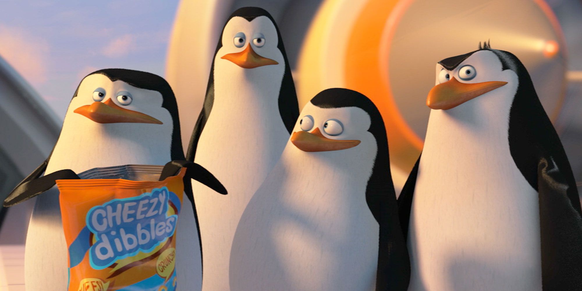 The penguins of Madagascar with a bag of cheezy dibbles