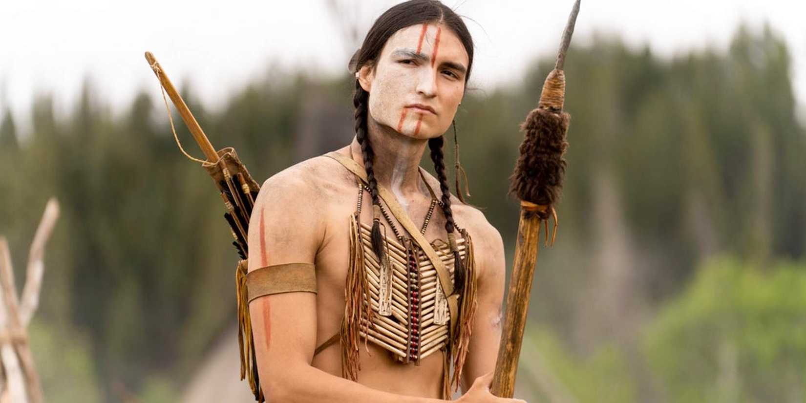 Dakota Beavers as Taabe, holding a spear in Prey.