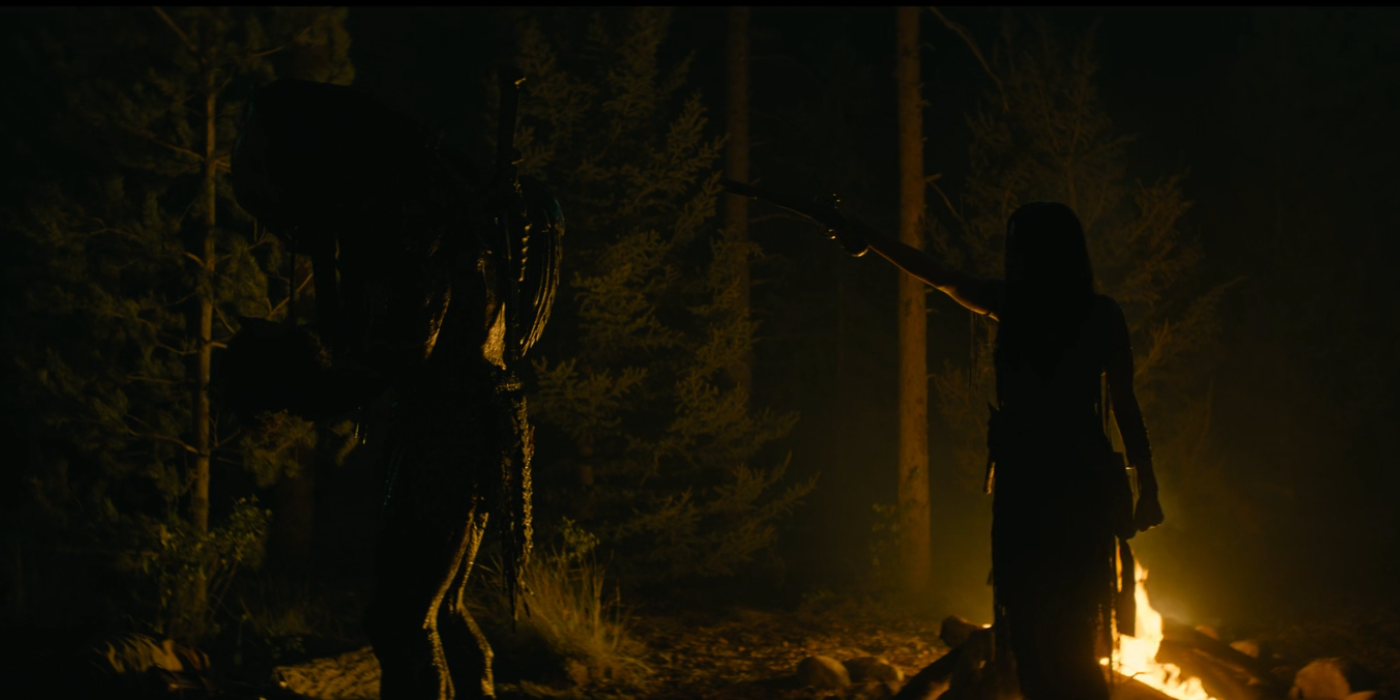 Naru pointing a gun to the Predator