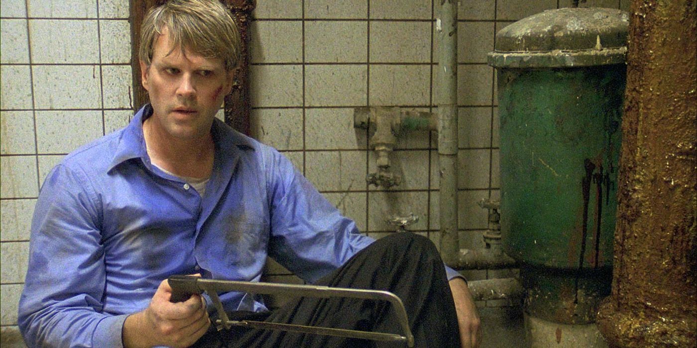 Cary Elwes holding a Saw in Saw