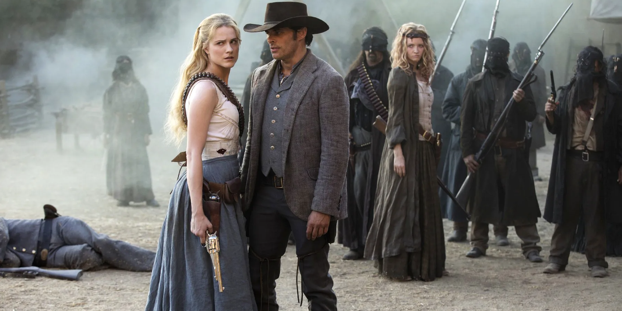 A man and woman stand close in a battlefield in Westworld
