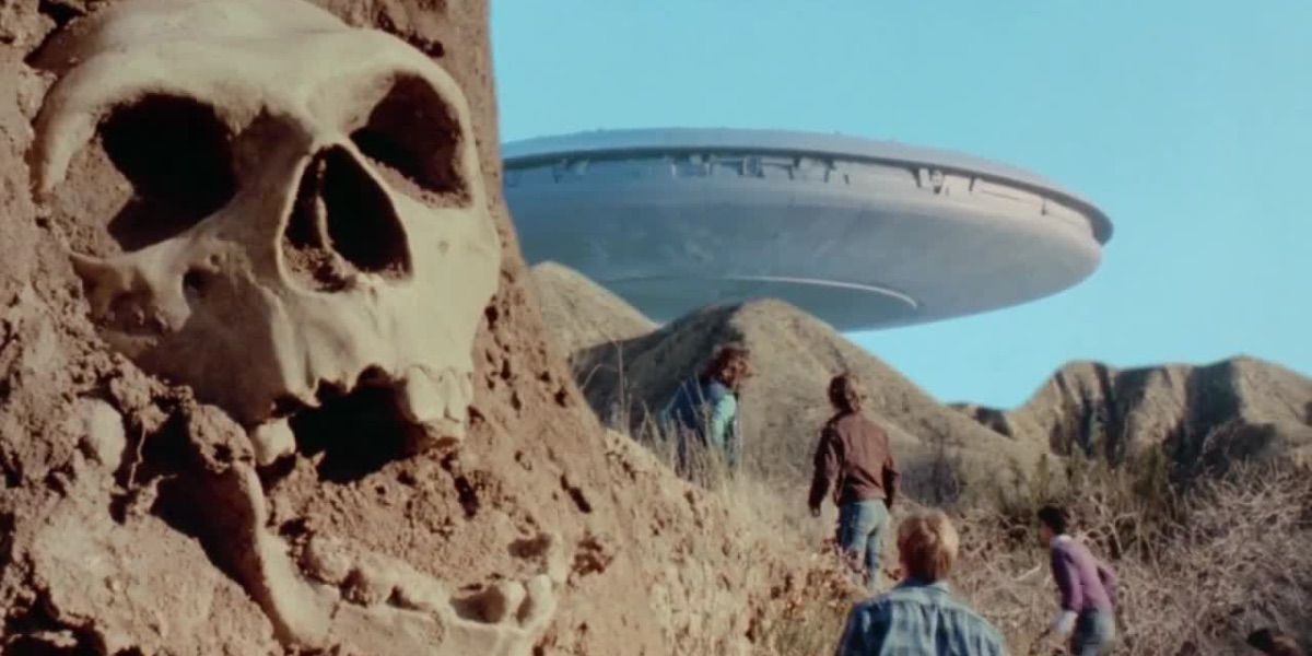 A spaceship looms with a skull in the foreground from V