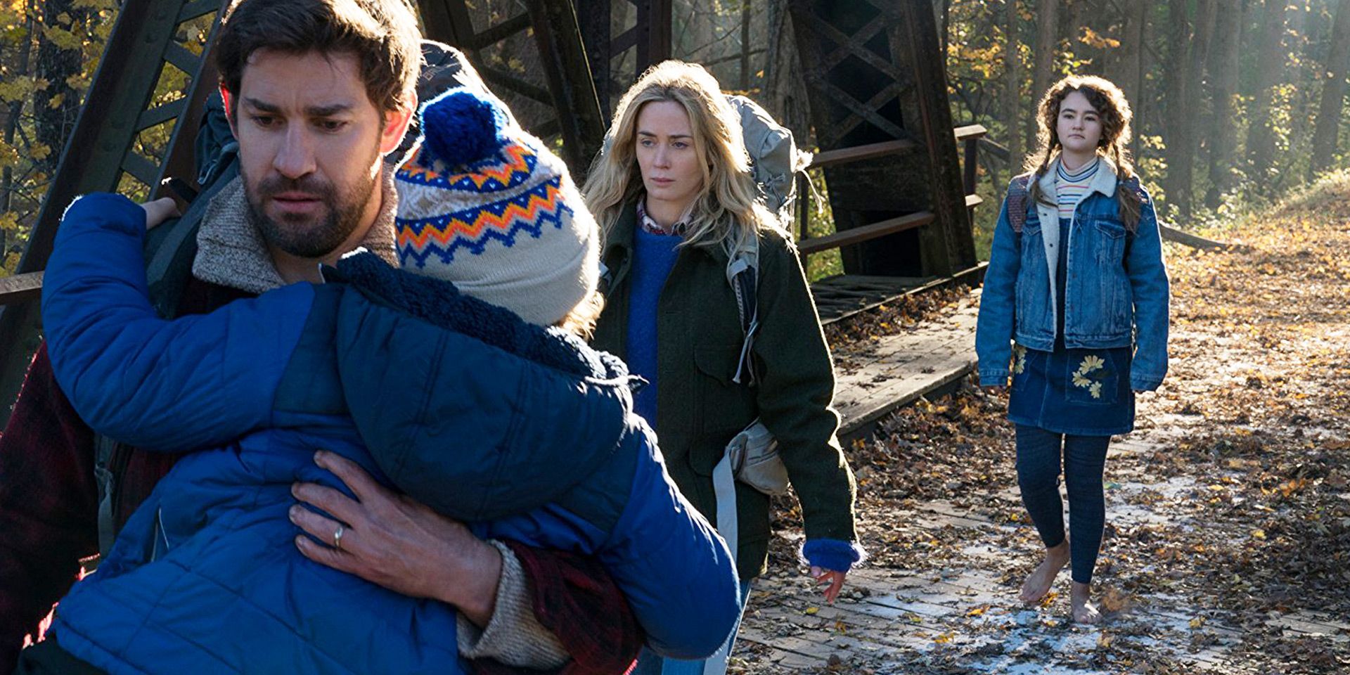 Characters from A Quiet Place walking through a woods