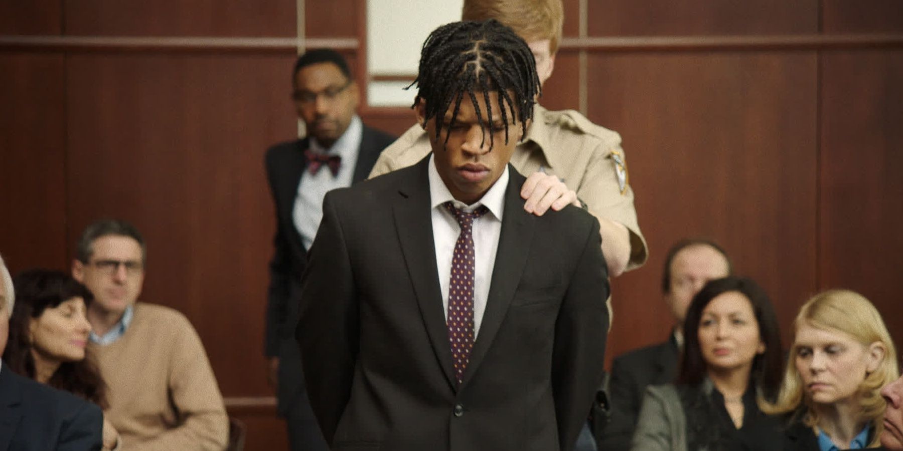 A boy being escorted into a courthouse in Canal Street Cropped
