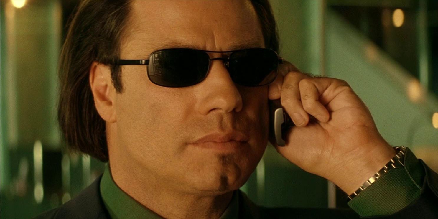 A close up shot of John Travolta holding a phone to his ear in the movie Swordfish