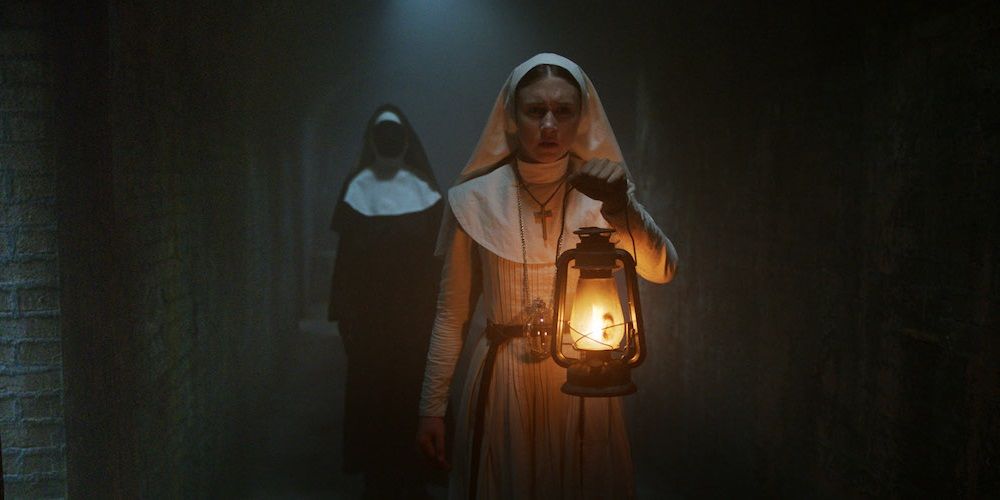 A ghost creeps up on a nun in The Nun