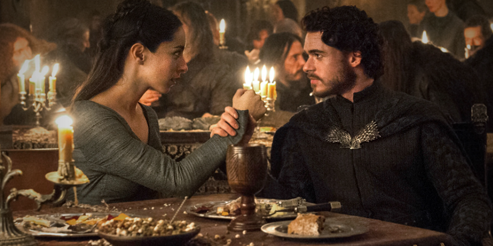 A man and woman at the dinner table in Game of Thrones 