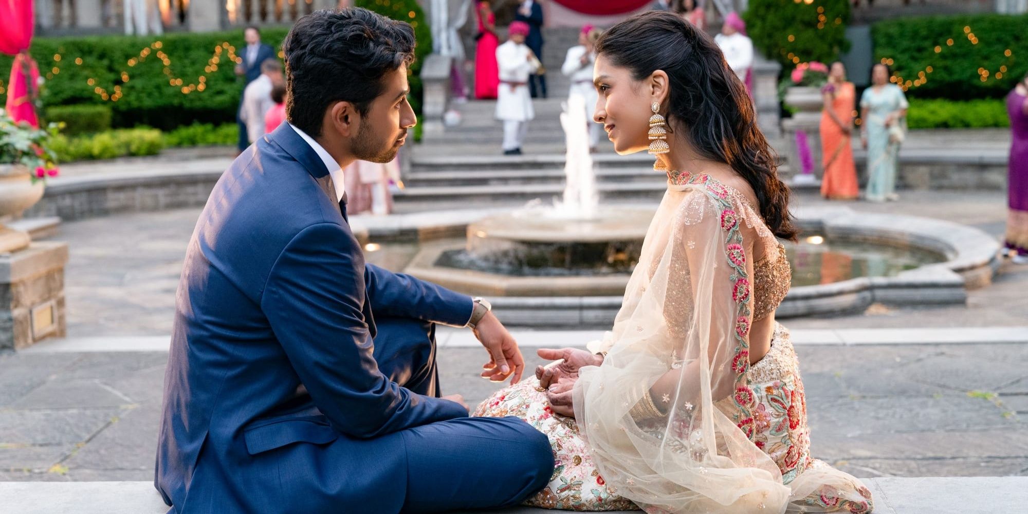 A man and woman sitting on steps in Wedding Season