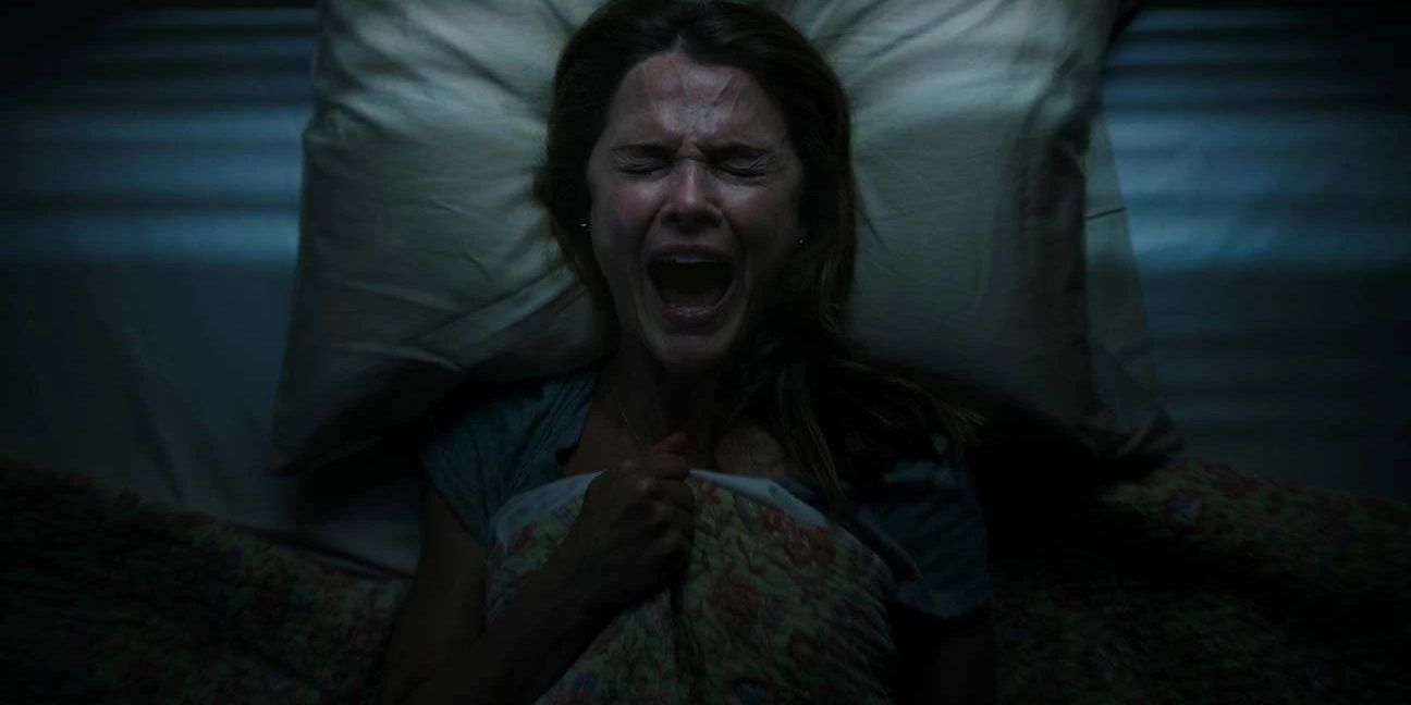A woman screaming in bed in Antlers