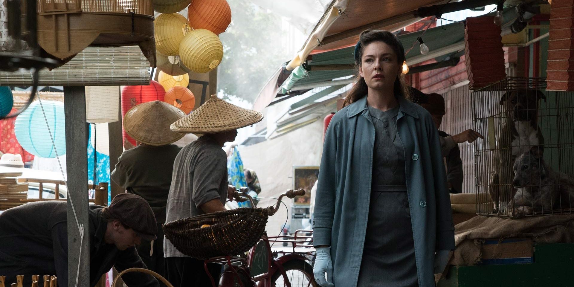 A woman walks in a busy street in The Man In the High Castle 