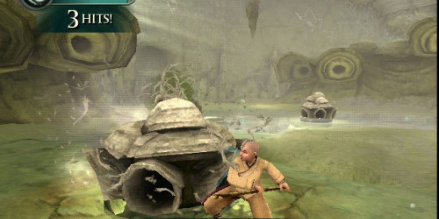 Aang segurando um pau e lutando no jogo The Last Airbender