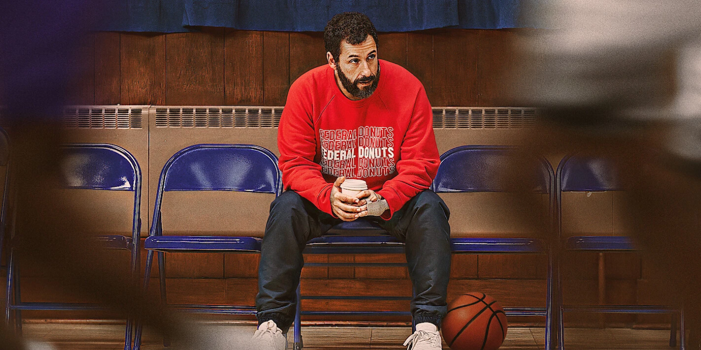 Adam Sandler's character in Hustle sitting in the bleachers