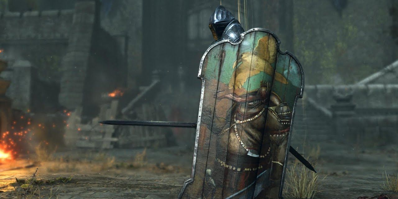 Player with the Adjudicator Shield equipped in Demon's Souls, a painted oversized shield 