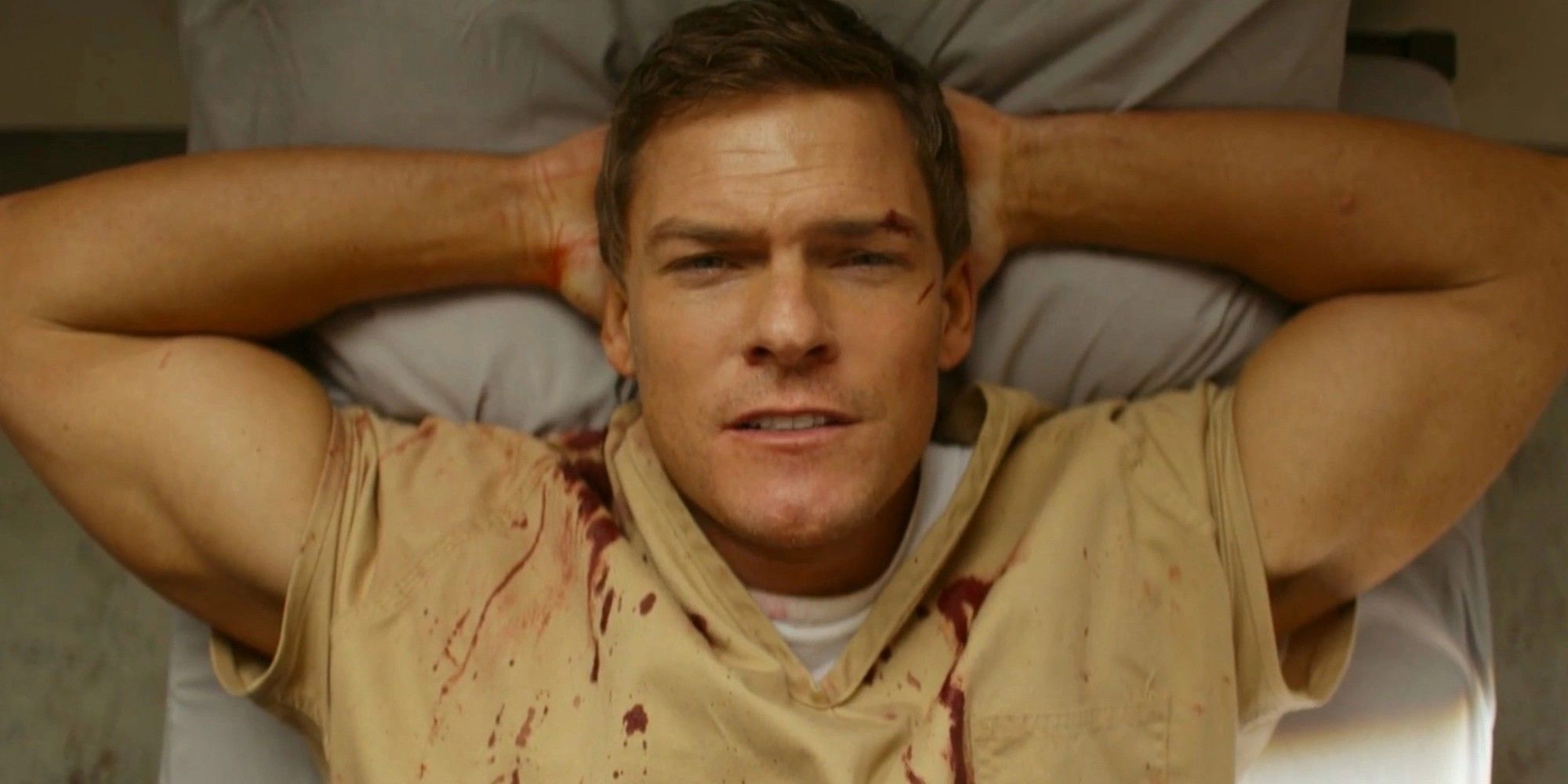 Jack Reacher lying down on a bed in Reacher