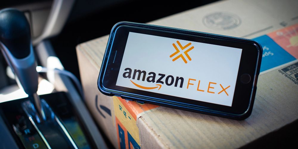 The Amazon Flex app is displayed on a phone inside a car