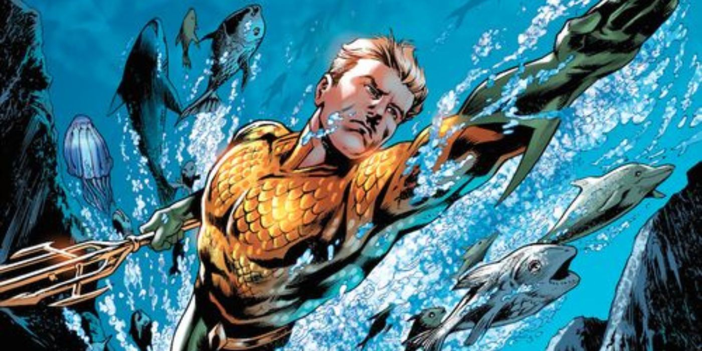 Aquaman swimming alongside numerous fish in DC Comics.