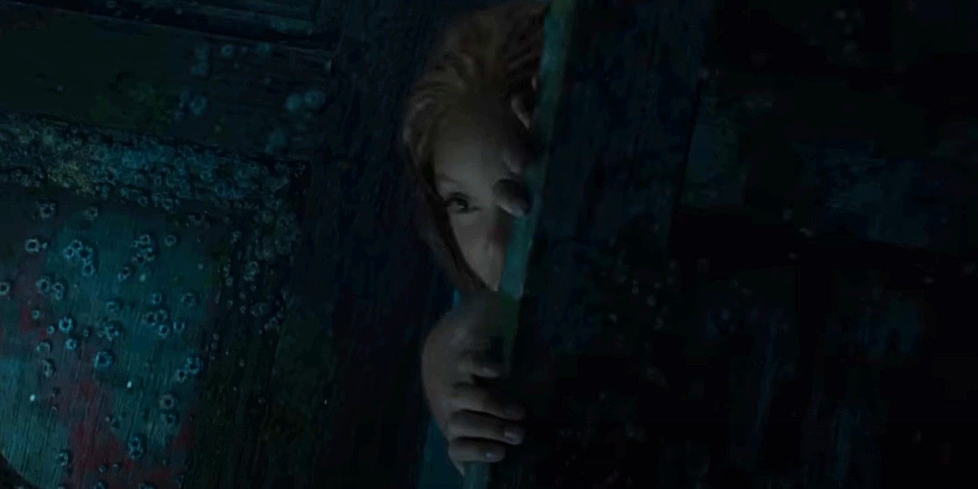 Ariel peeking around a piece of a shipwreck in The Little Mermaid live-action trailer