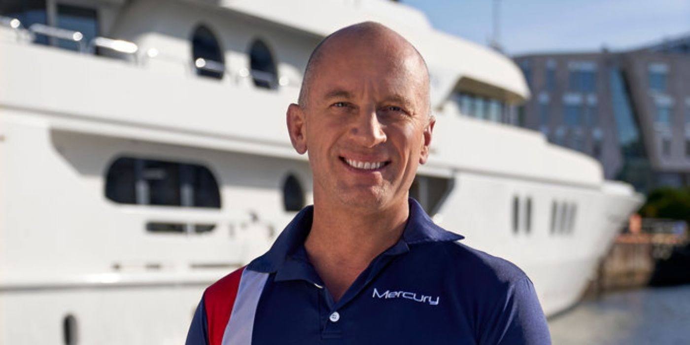 Below Deck Adventure's Captain Kerry posing in front of yacht