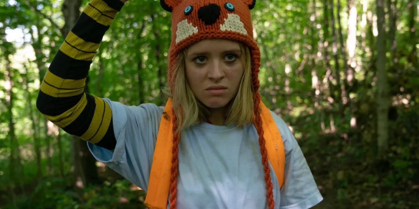 Becky holding up a weapon in the forest in Becky (2020)