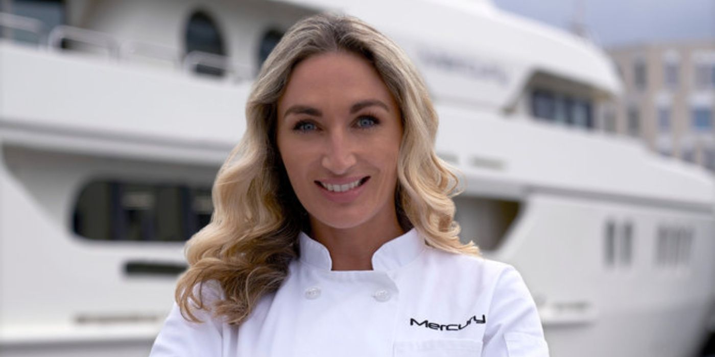 Below Deck Adventure's Chef Jess Condy in white chef's uniform, in front of a yacht