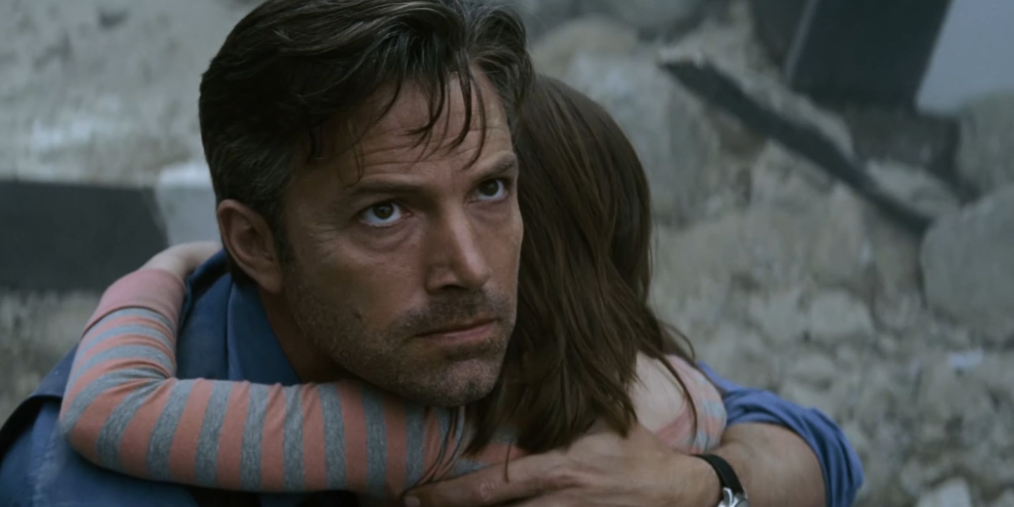 Bruce Wayne glaring at Superman in the sky while comforting a child in Batman V Superman Dawn Of Justice (2016)