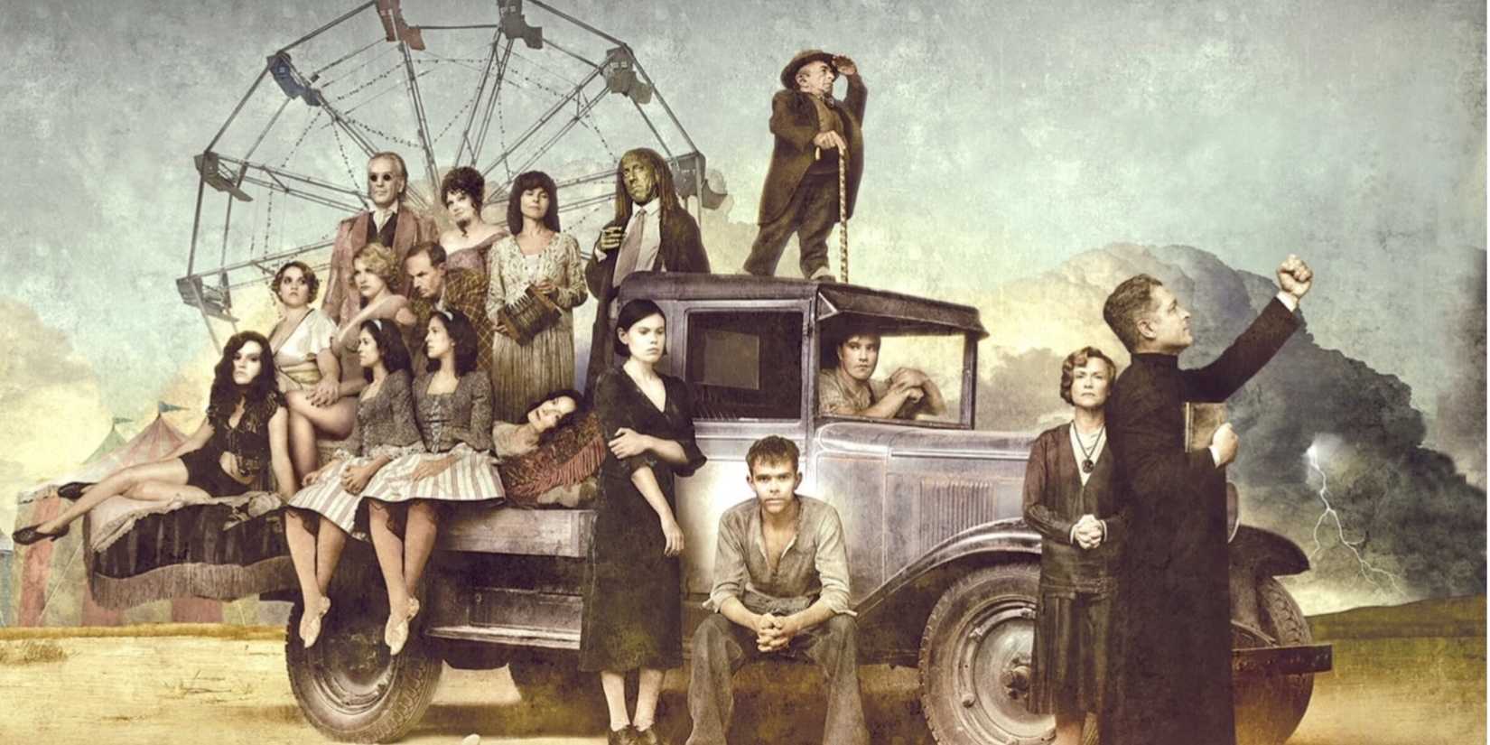 The cast of Carnivale sits and stands on a truck with a ferris wheel behind them.