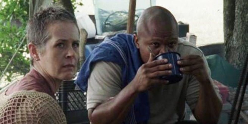 Carol and T Dog sit together in The Walking Dead