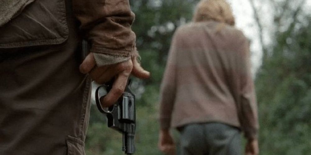 Carol holds a gun behind Lizzie&rsquo;s back in The Walking Dead