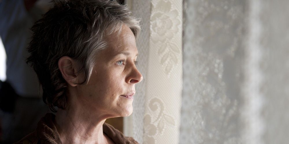 Carol looks outside the window in The Walking Dead