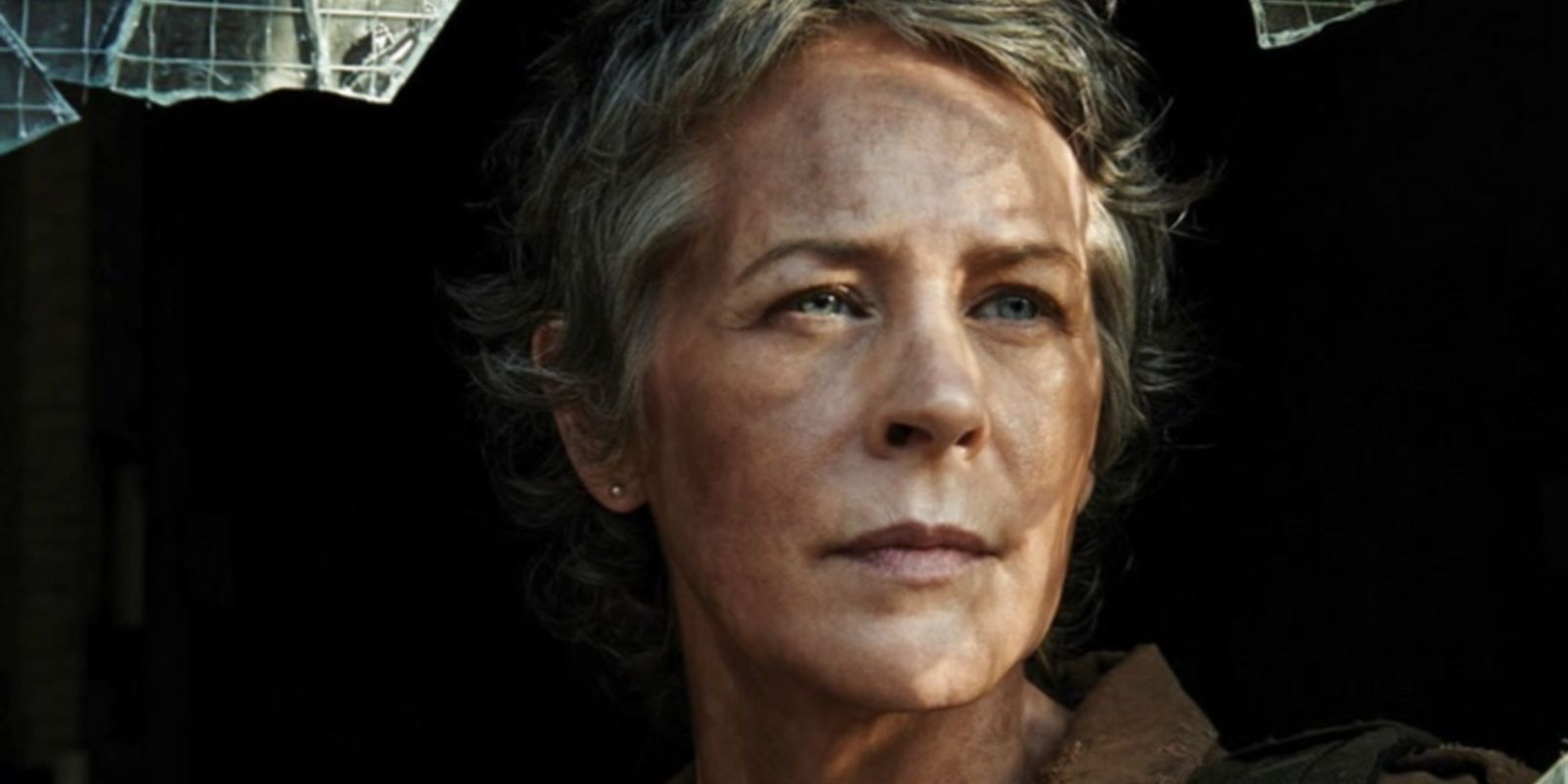 Carol looks through a shattered window in The Walking Dead 