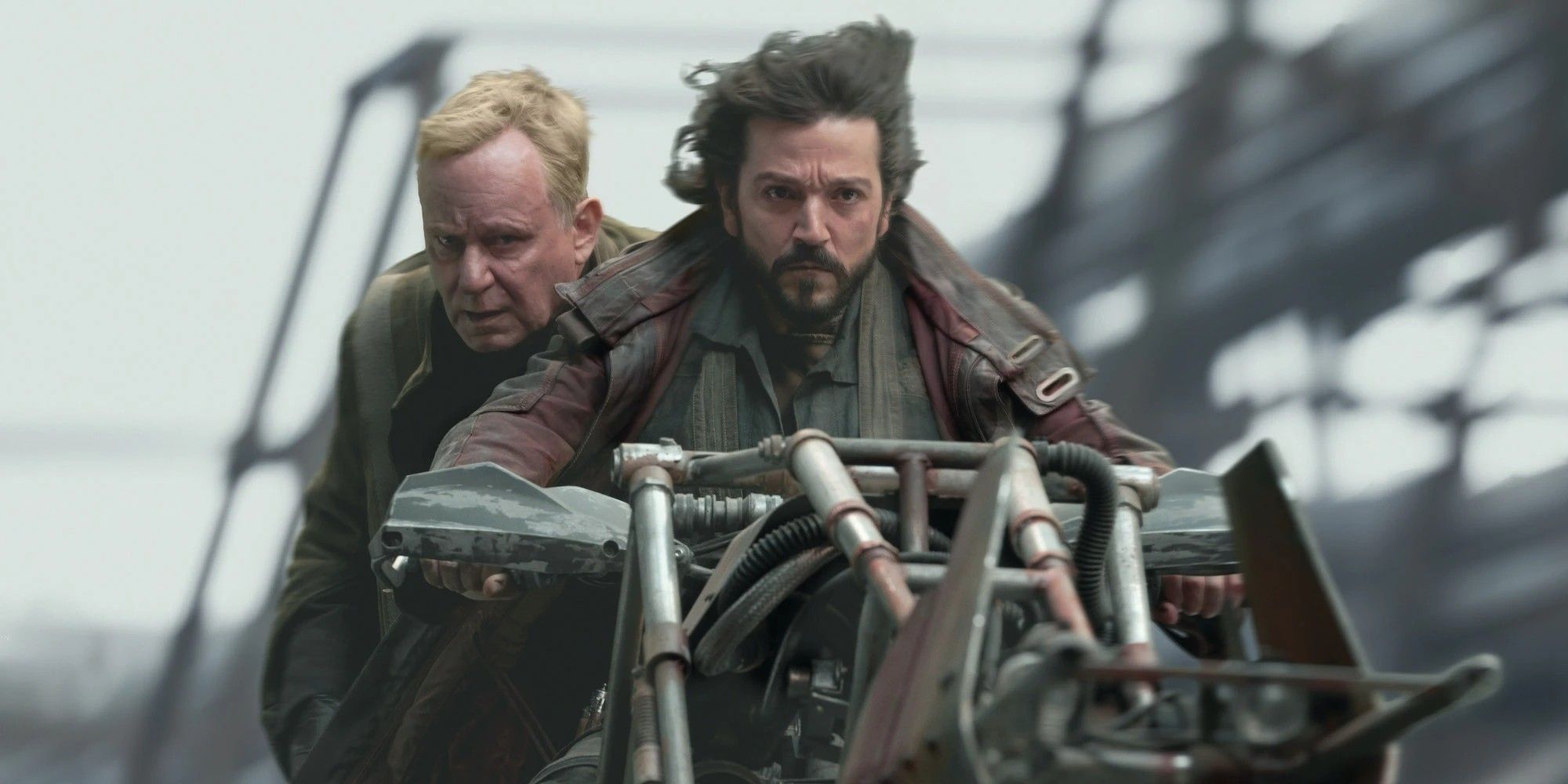 Cassian Andor and Luthen Rael riding on a bike in Andor
