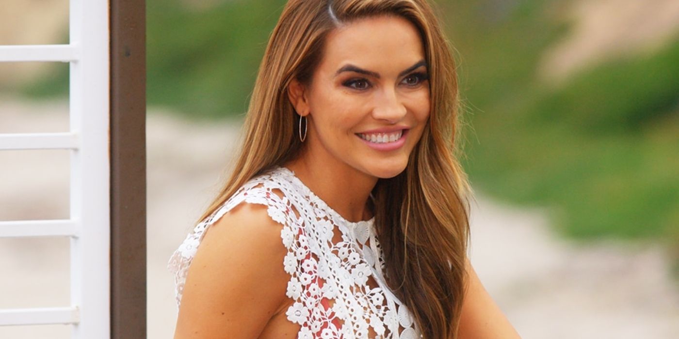 Chrishell Stause wearing a white dress and smiling on Selling Sunset