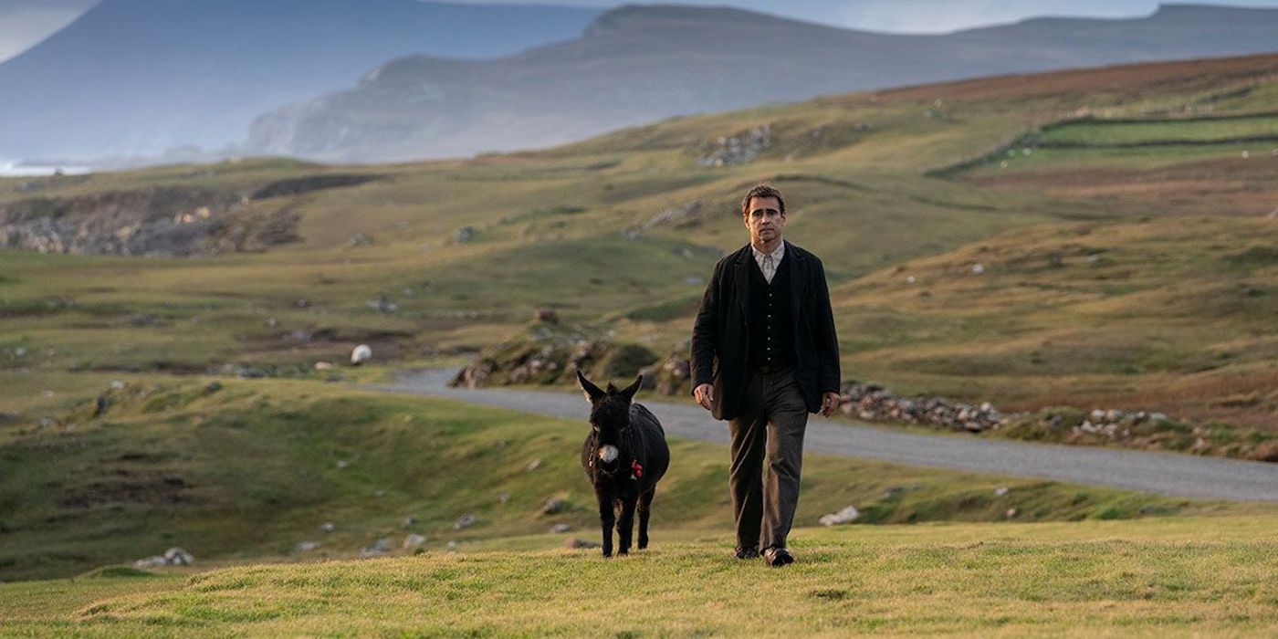 Colin Farrell and a donkey walk across a field in The Banshees Of Inisherin