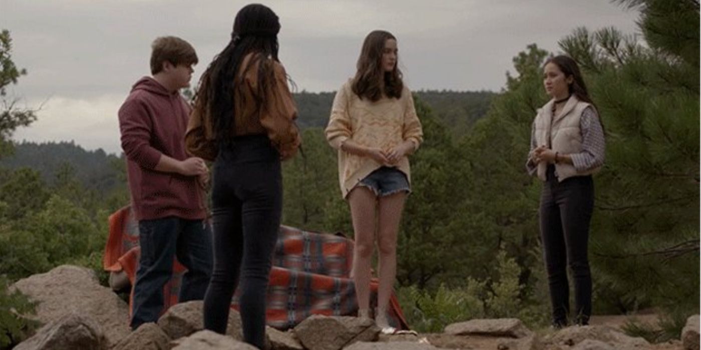 Harper, Bridger, Madison and Max standing in the woods having a discussion in Big Sky