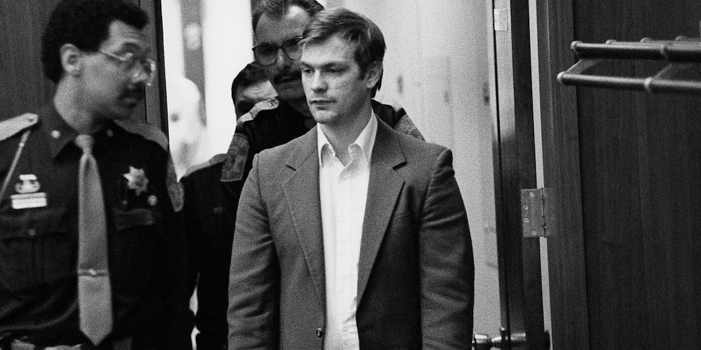 Jeffrey Dahmer in black and white being led by police officers in Conversations With A Killer