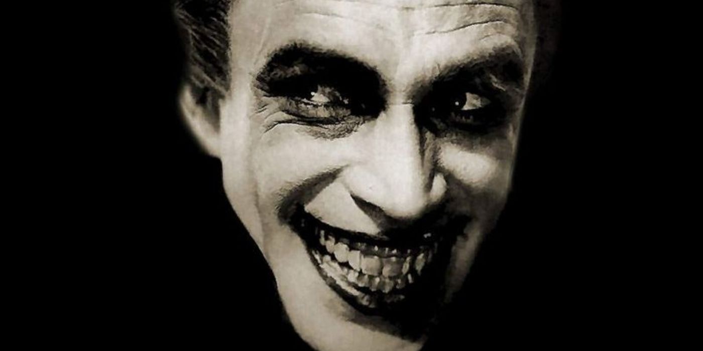 A man grinning in an evil and creepy way in The Man Who Laughs