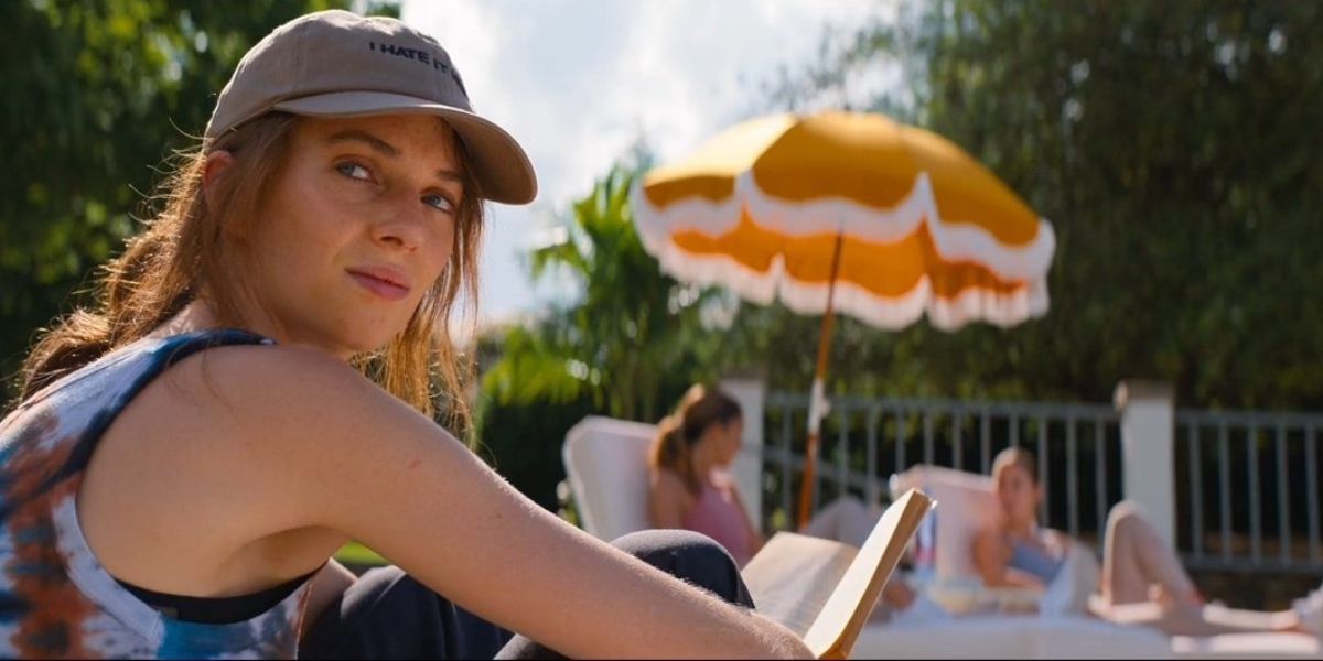 Eleanor sitting outside, reading a book in Do Revenge