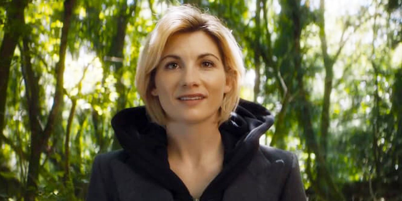 Jodie Whittaker smiling in a forest in Doctor Who