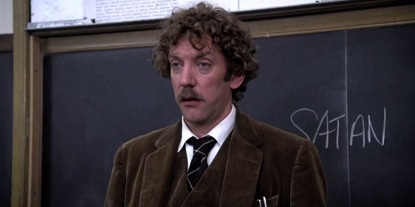 Donald Sutherland standing by the blackboard in class in Animal House