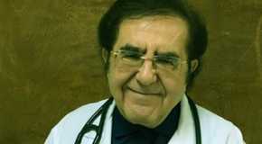 Dr. Now My 600-lb Life wearing white coat smiling