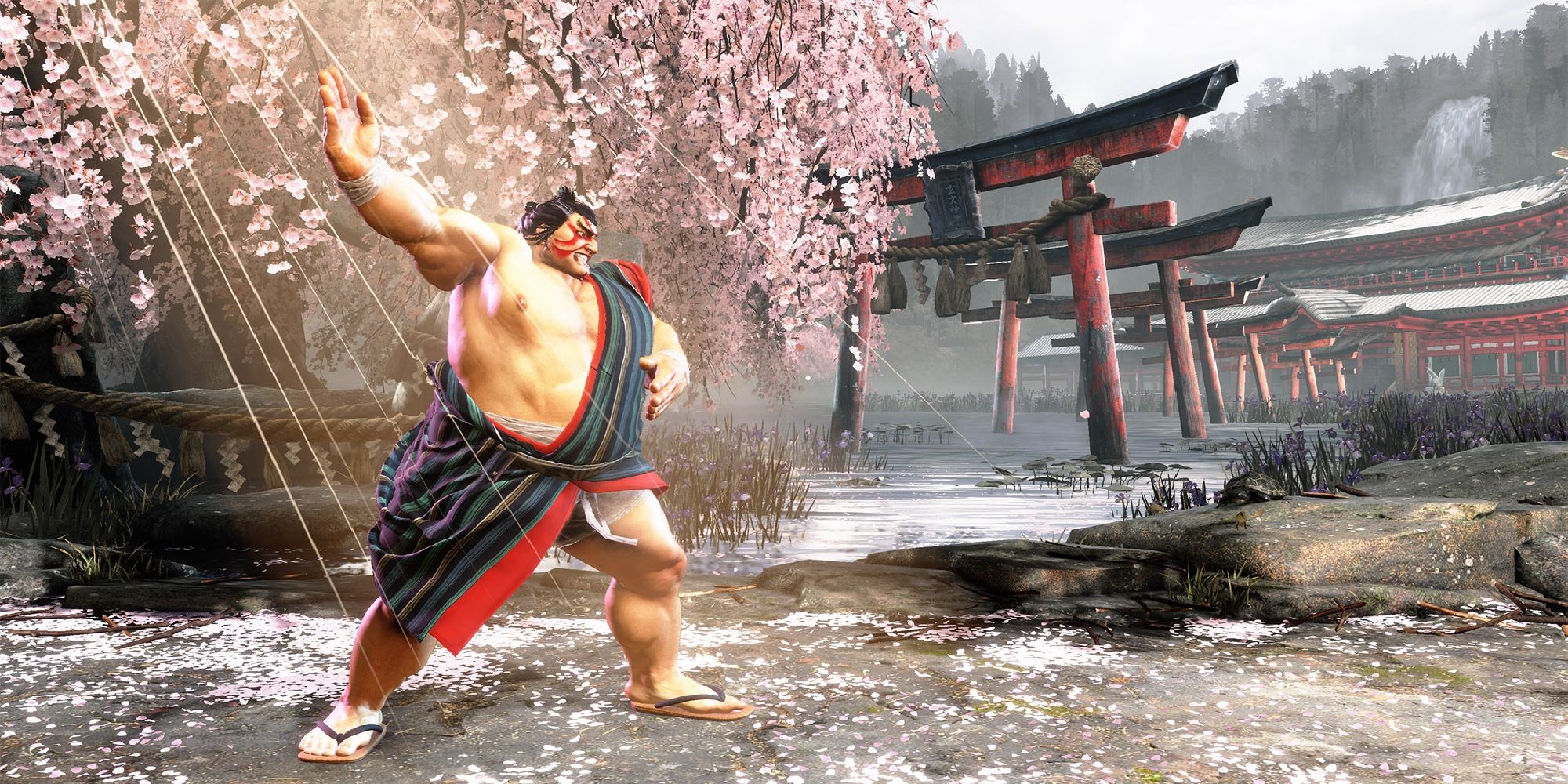 E Honda, a returning character Street Fighter 6 in sumo gear, posing ready to fight in front of a Shinto shrine.