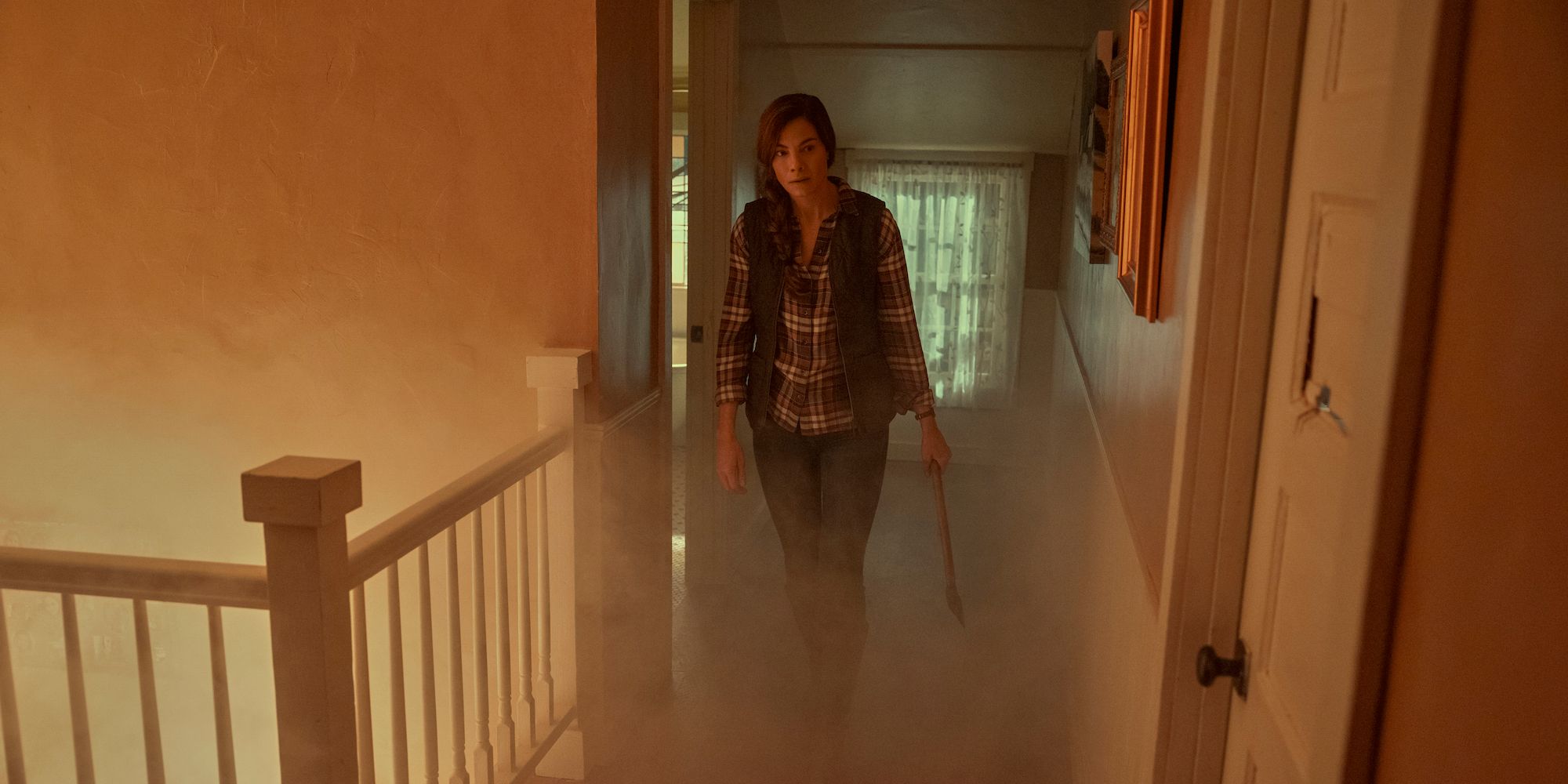 A woman walks through a burning house in Echoes 