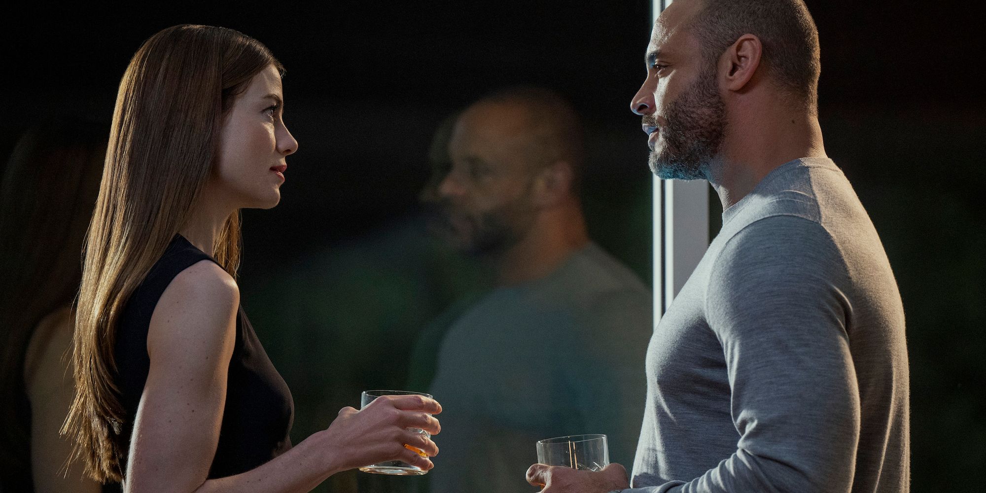 Michelle Monaghan and Daniel Sunjata drinking by a window in Echoes