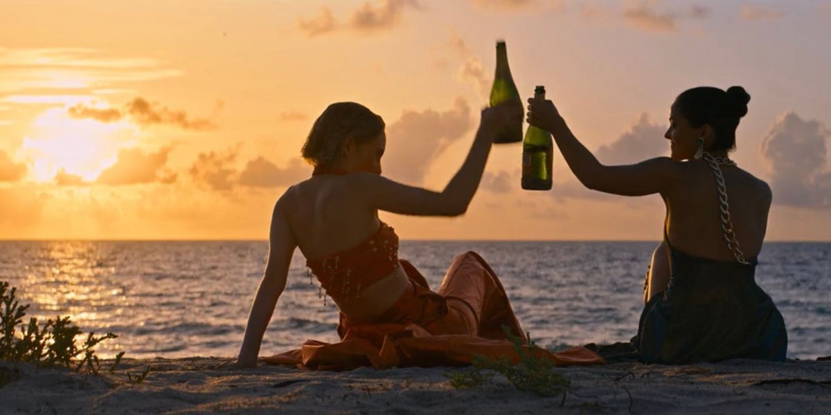 Eleanor and Drea toasting on the Beach in Do Revenge