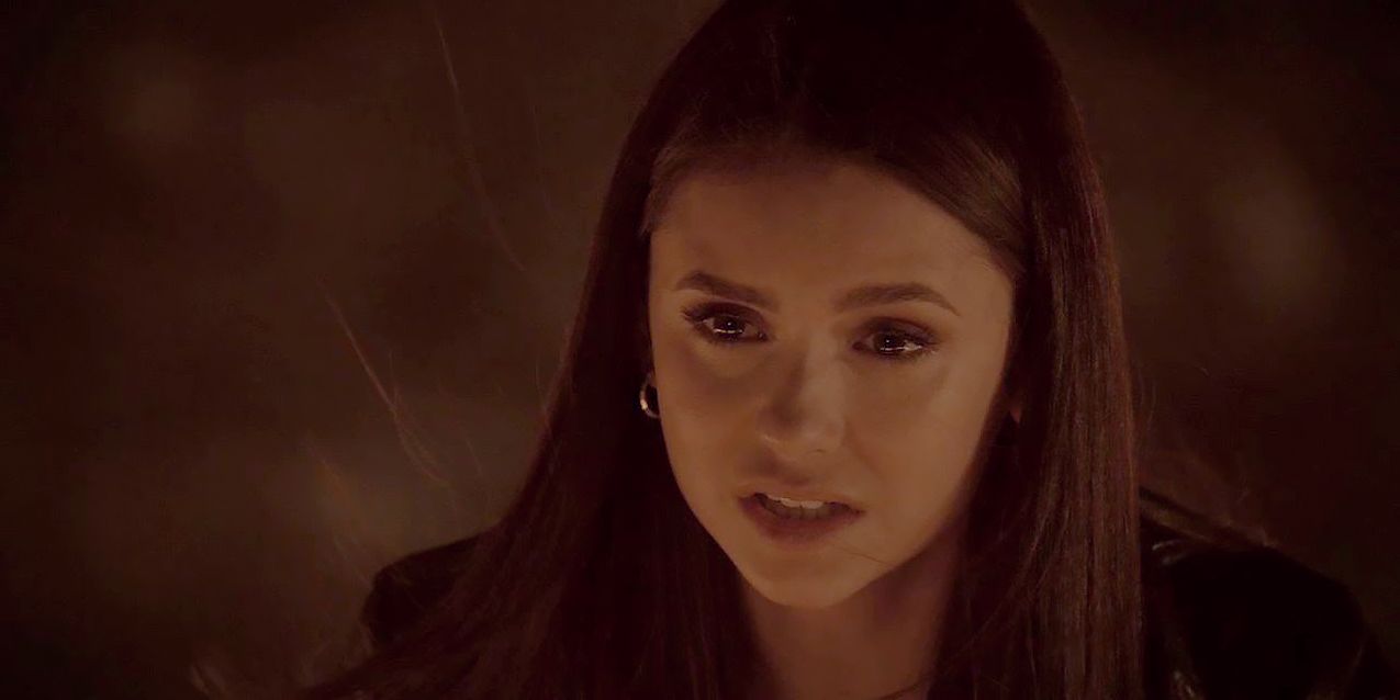 Elena Gilbert looking distressed in front of a fire on TVD