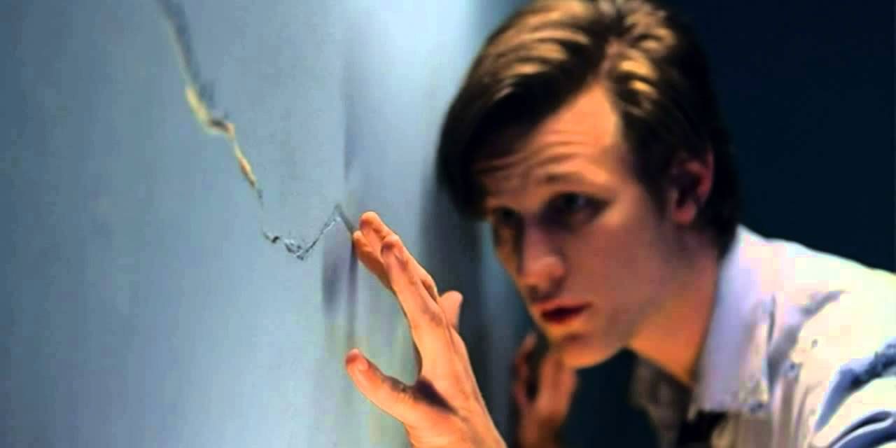 Eleventh Doctor investigating a crack in the wall in Doctor Who